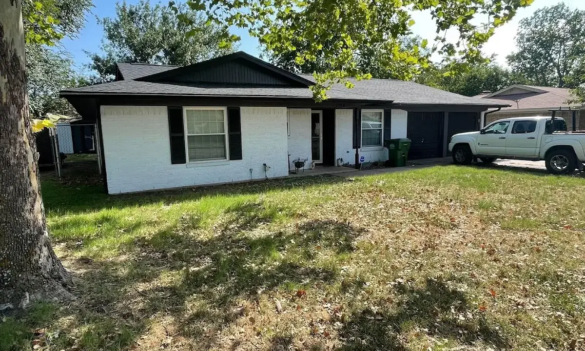 Professional roofing crew working on a residential roof in Arkadelphia